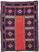 AN UZBEK SUZANI EMBROIDERED TEXTILE, with diamond motifs in purple, yellow, green, blue, black,