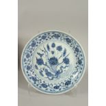 A LARGE CHINESE BLUE AND WHITE PORCELAIN DISH, painted with central floral spray with lotus, 31cm