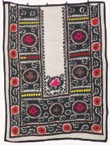 AN UZBEK SUZANI EMBROIDERED TEXTILE, with floral motifs and decorative roundels in pink, red, green,