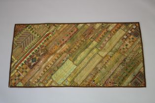 AN INDIAN GILT THREAD EMBROIDERED TEXTILE WITH INSET MIRROR ROUNDELS, 148cm x 77cm.