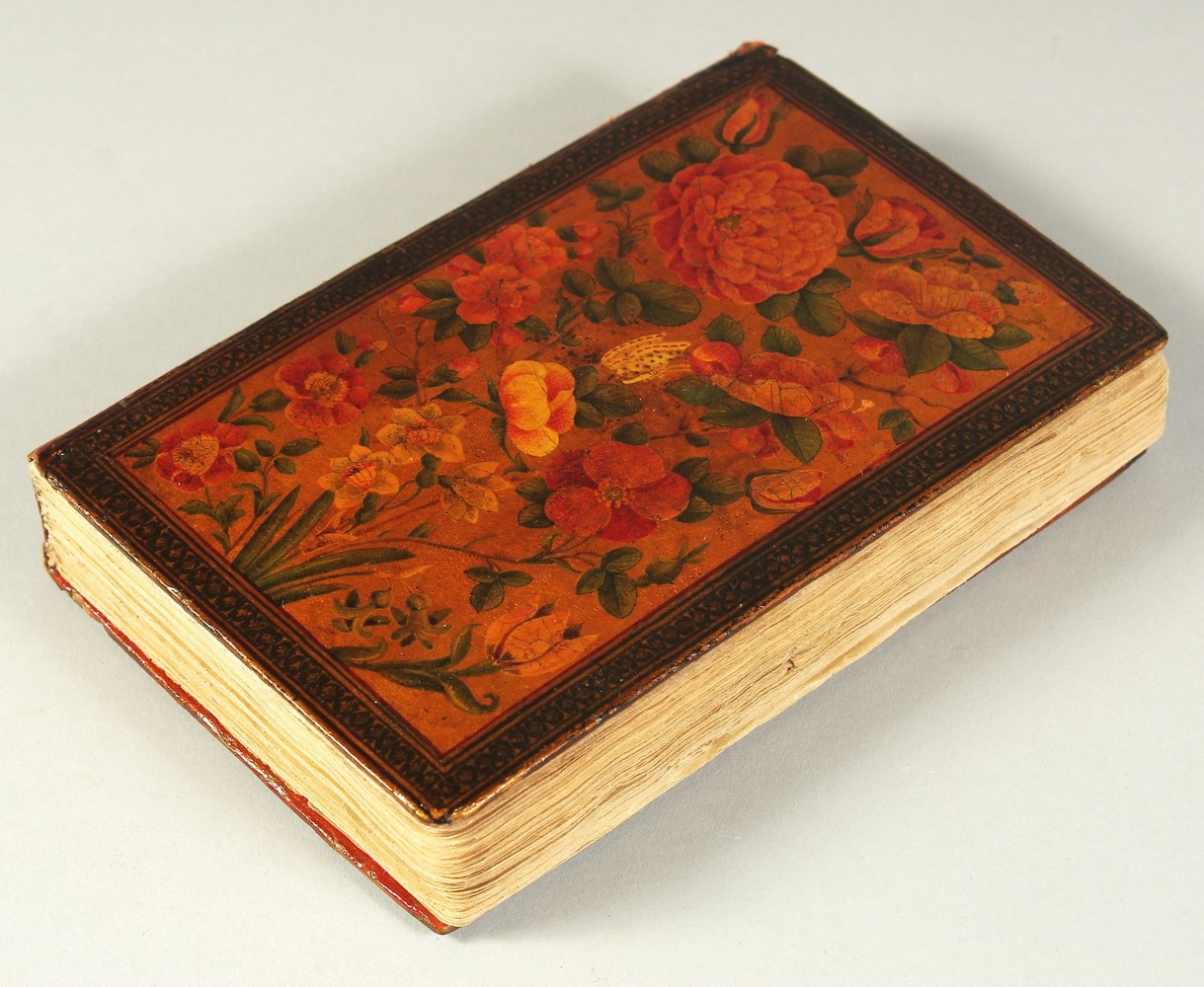 A FINE PERSIAN QAJAR LACQUERED COVER QURAN, signed and dated, the covers painted with flora, 15cm