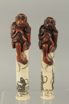 A PAIR OF CHINESE BONE AND CARVED HARDWOOD MONKEY-FORM SCROLL HOLDERS, the cylinders etched with