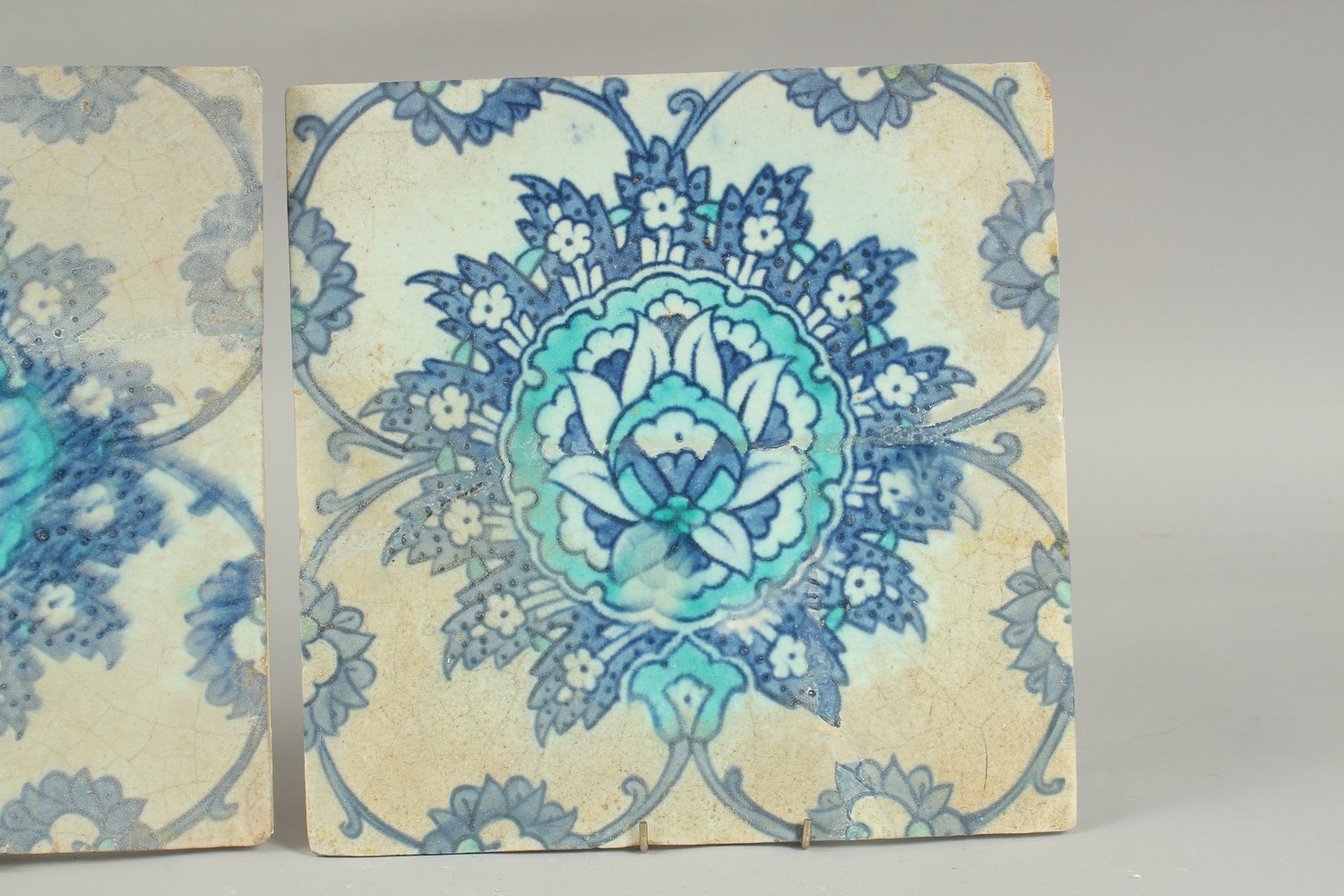 TWO EARLY 17TH CENTURY OTTOMAN IZNIK TILES, depicting a large lotus flower, (2). - Image 3 of 6