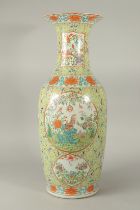 A LARGE 19TH CENTURY CHINESE GREEN GROUND FAMILLE ROSE PORCELAIN VASE, painted with various panels