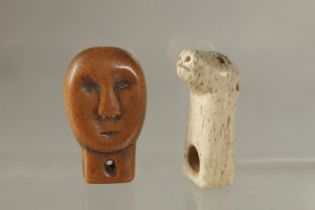 TWO ANTIQUE CARVED INUIT JEWELLERY PIECES, one of a carved bone animal, the other carved as a