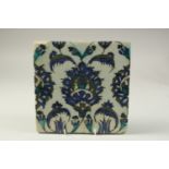 A 17TH CENTURY SYRIA DAMASCUS GLAZED POTTERY TILE, 23cm x 23cm.