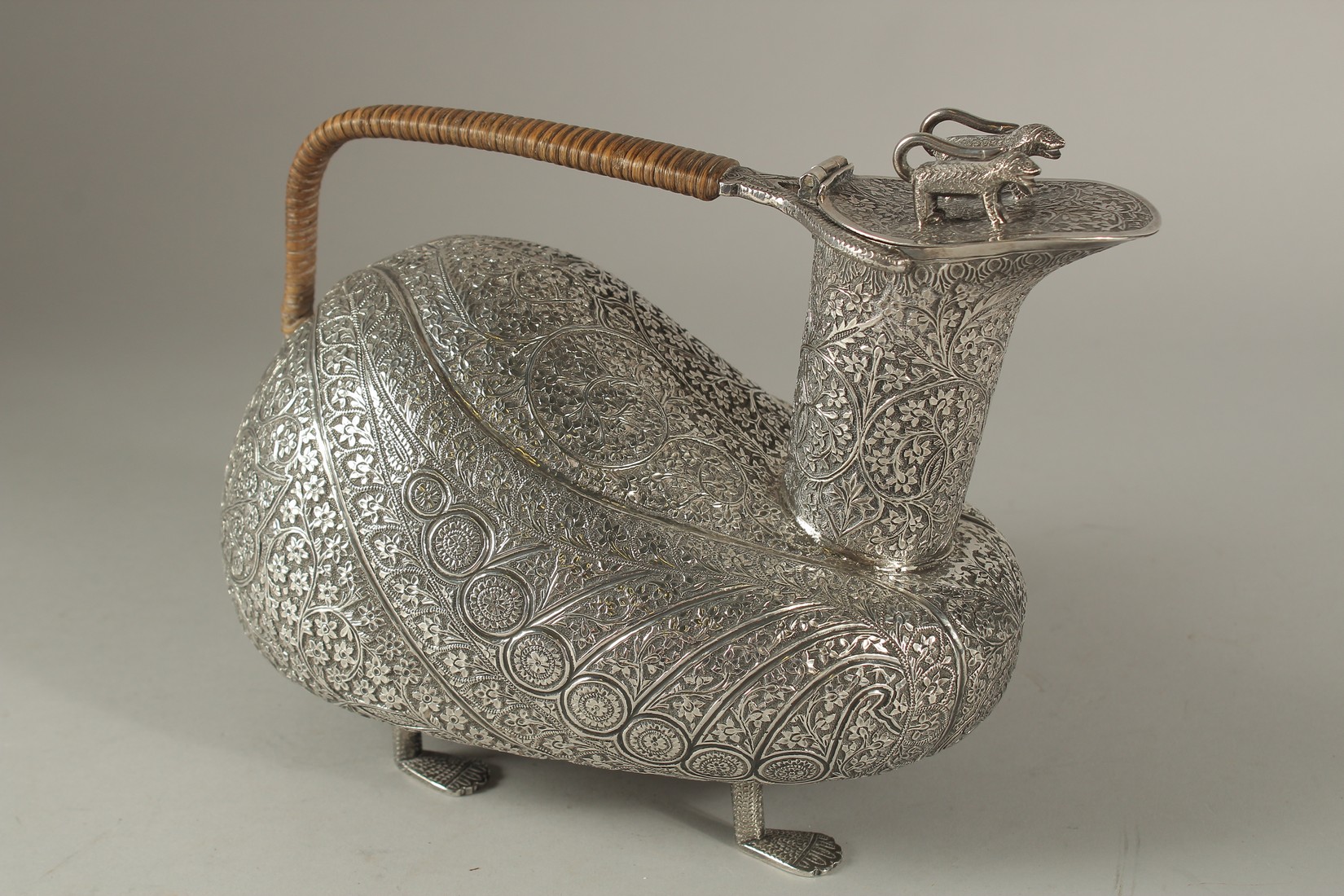 A VERY FINE AND UNUSUAL INDIAN KASHMIR ENGRAVED SILVER VESSEL, intricately chased with finely