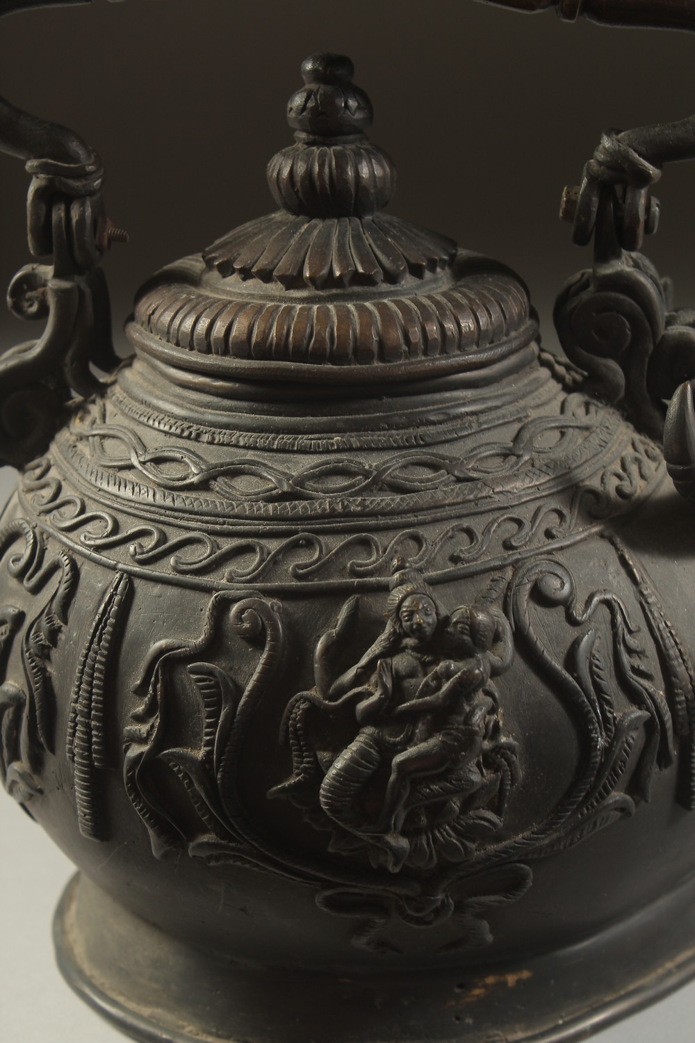 A FINE AND UNUSUAL INDIAN BRONZE EWER, with bulls' head spout and relief hindu deities around the - Image 3 of 5