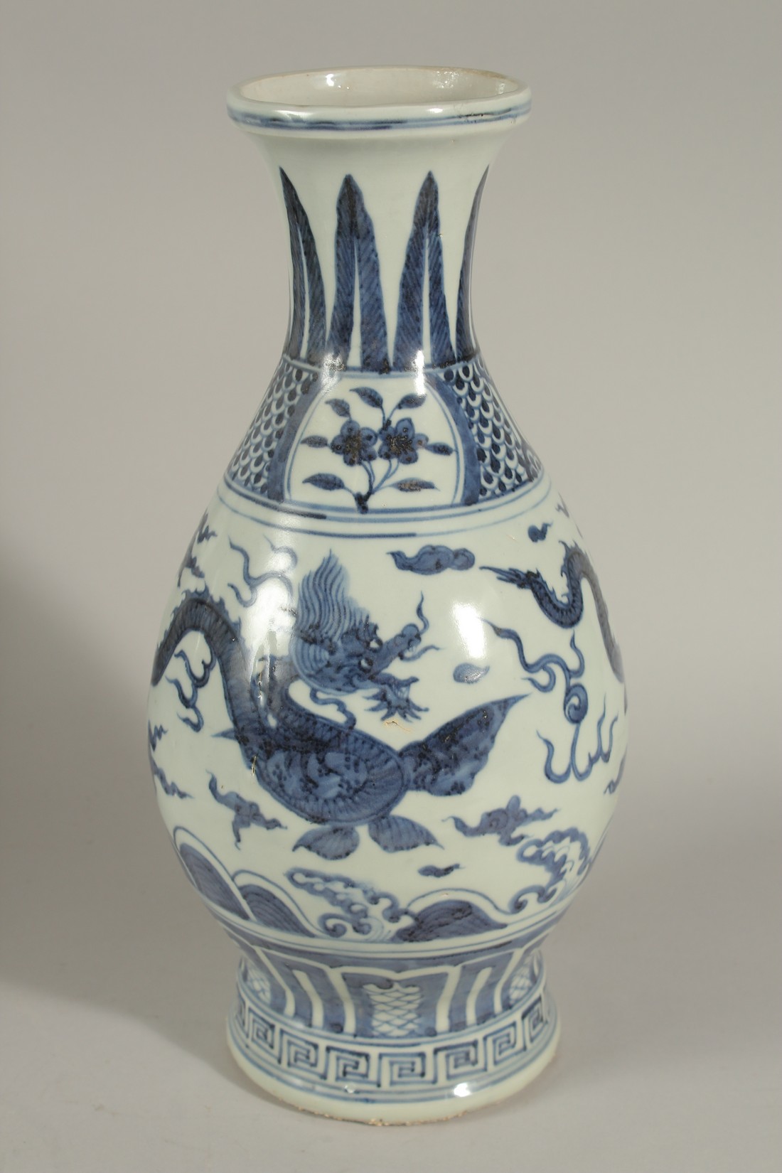 A CHINESE BLUE AND WHITE PORCELAIN DRAGON VASE, designed with two dragons chasing the flaming