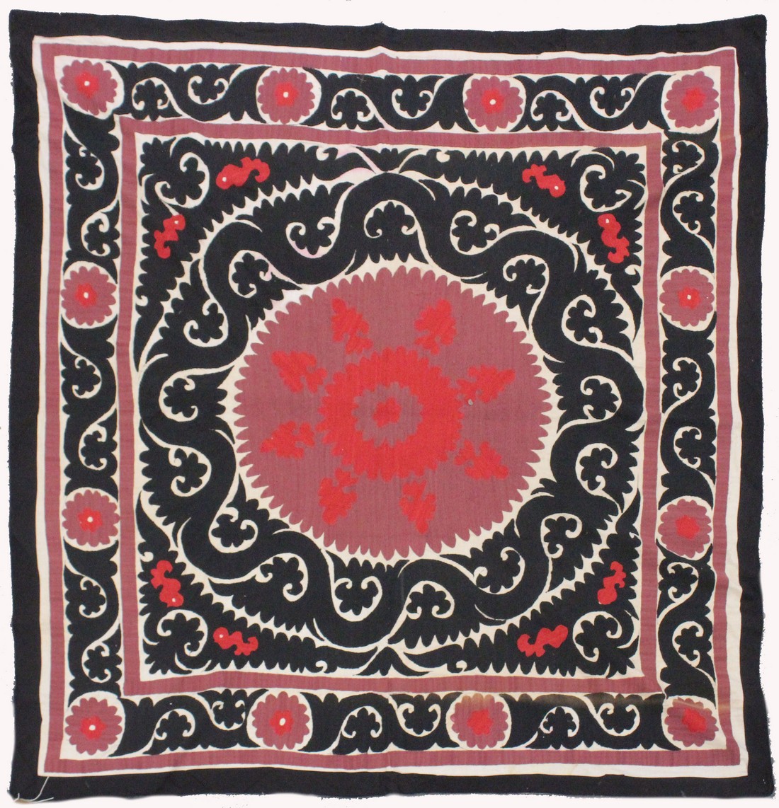 AN UZBEK SUZANI EMBROIDERED TEXTILE, with maroon, red, and black motif on cream ground, 158cm x