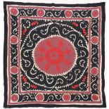 AN UZBEK SUZANI EMBROIDERED TEXTILE, with maroon, red, and black motif on cream ground, 158cm x