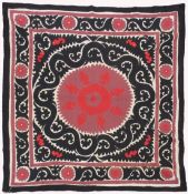 AN UZBEK SUZANI EMBROIDERED TEXTILE, with maroon, red, and black motif on cream ground, 158cm x
