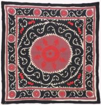 AN UZBEK SUZANI EMBROIDERED TEXTILE, with maroon, red, and black motif on cream ground, 158cm x