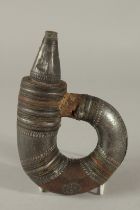 A 18-19TH CENTURY ARAB OMANI SILVER MOUNTED POWDER FLASK, 21cm long.