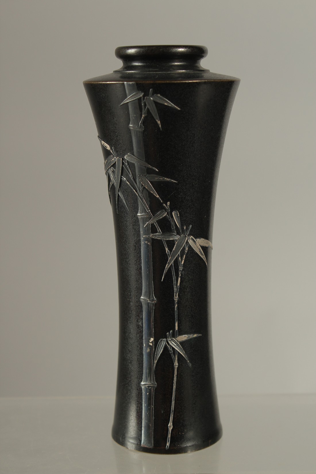 A FINE JAPANESE SILVER INLAID BRONZE VASE, with bamboo design and signed to the base, 15cm high.