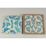 TWO EARLY 17TH CENTURY OTTOMAN IZNIK BLUE AND WHITE GLAZED POTTERY TILES, each approx. 25cm