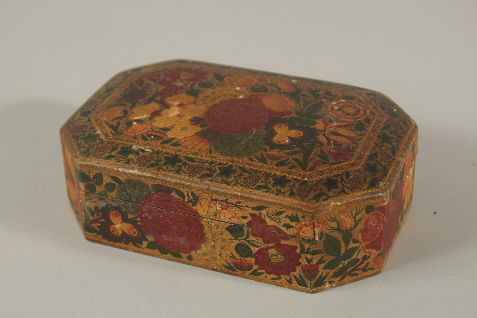 A 19TH CENTURY INDIAN KASHMIRI GILDED AND LACQUERED PAPIER MACHE BOX, SIGNED BY SUFFERING MOSES,