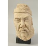 A CARVED CLAY HEAD SCULPTURE, raised on stand.