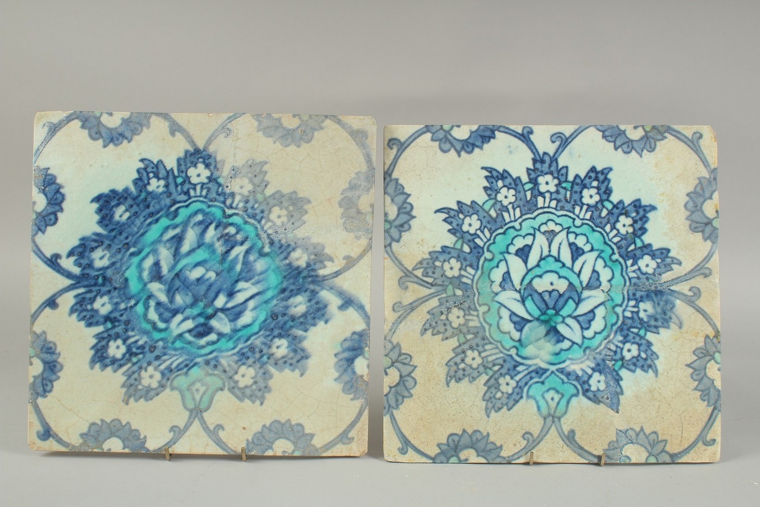 TWO EARLY 17TH CENTURY OTTOMAN IZNIK TILES, depicting a large lotus flower, (2).