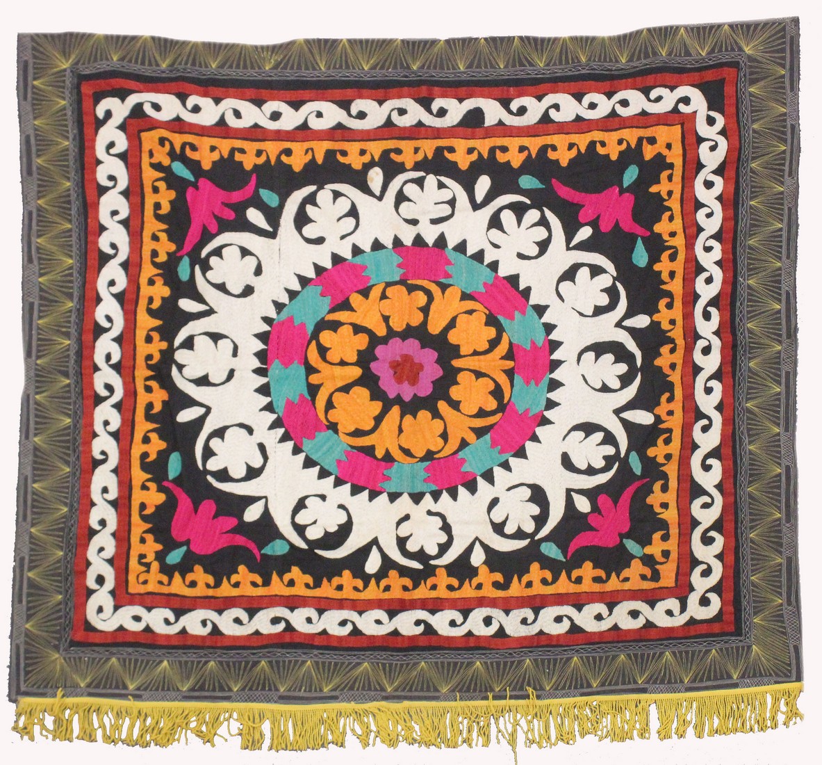 AN UZBEK SUZANI EMBROIDERED TEXTILE, with central foliate motif in orange, pink, red, green,