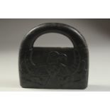 A CARVED STONE HANGING WEIGHT, 20cm x 19cm.