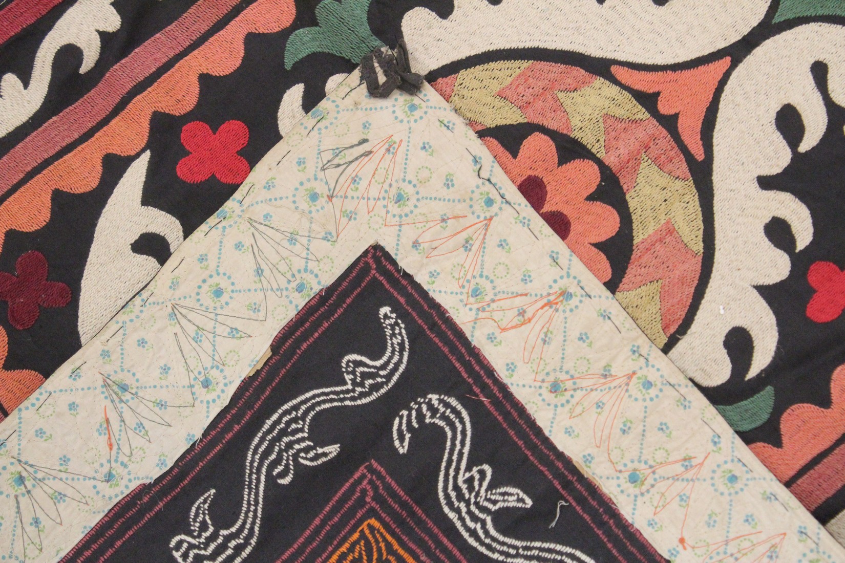 AN UZBEK SUZANI EMBROIDERED TEXTILE, with central foliate motif in orange, green, maroon, red, and - Image 3 of 3