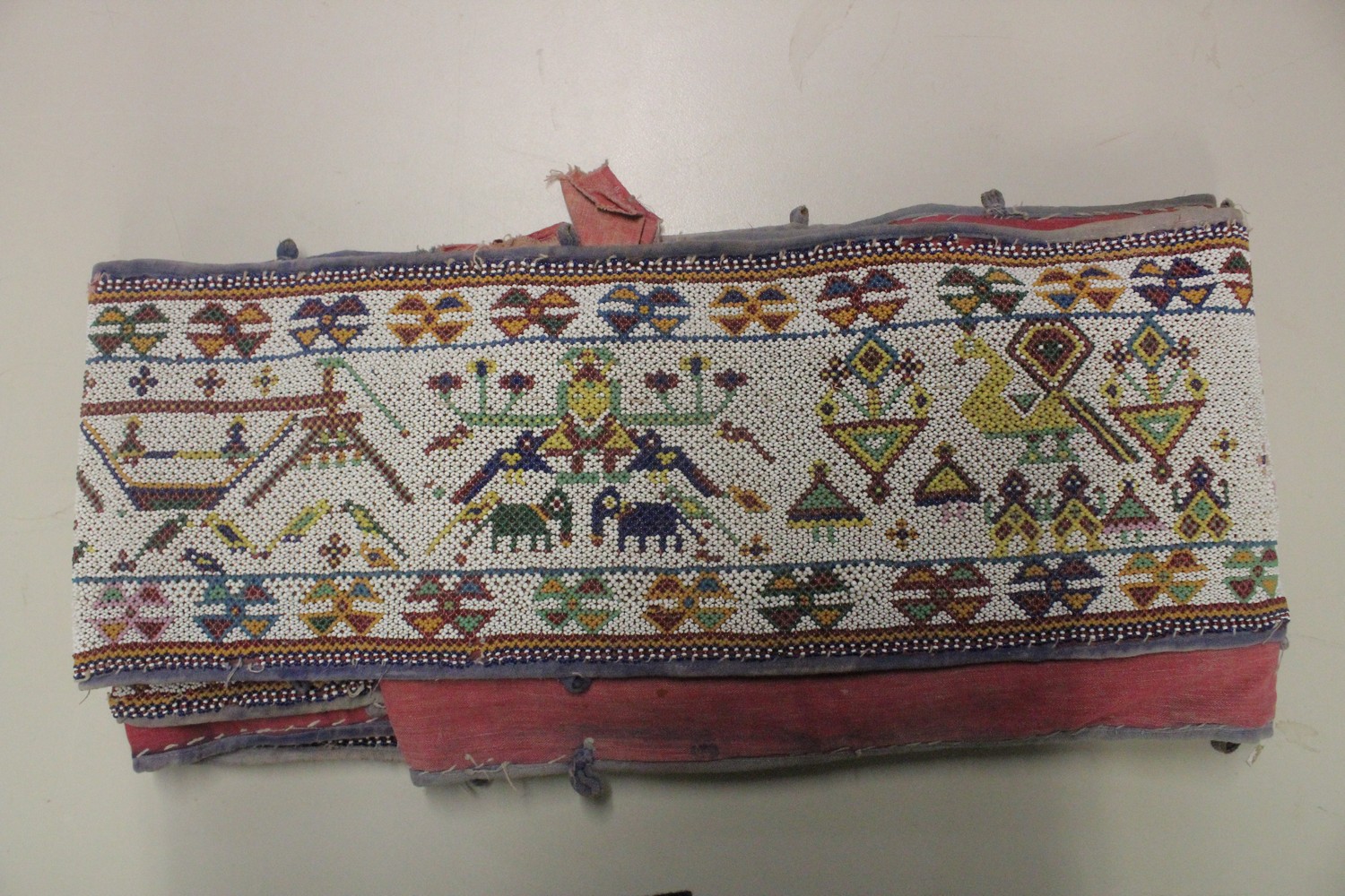 AN EARLY 20TH CENTURY WESTERN INDIAN GUJARAT LONG BEADWORK PANEL, with polychrome stylised geometric