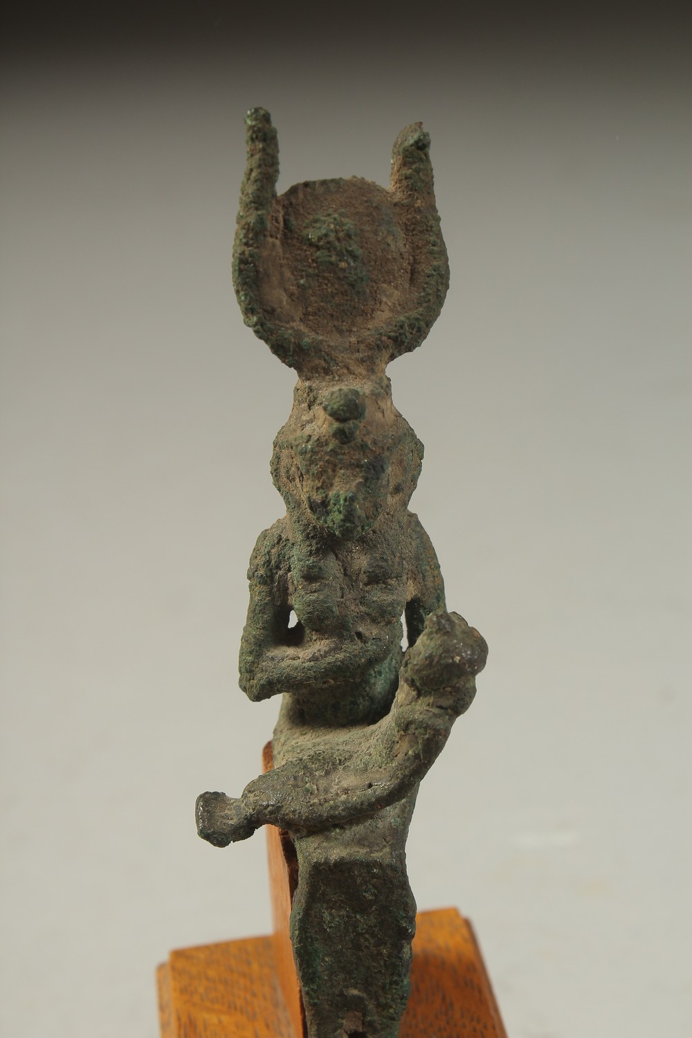A RARE ANCIENT EYGPTIAN BRONZE FIGURE OF ISIS NURTURING HORUS, on a wooden stand, bronze 12cm high. - Image 3 of 4