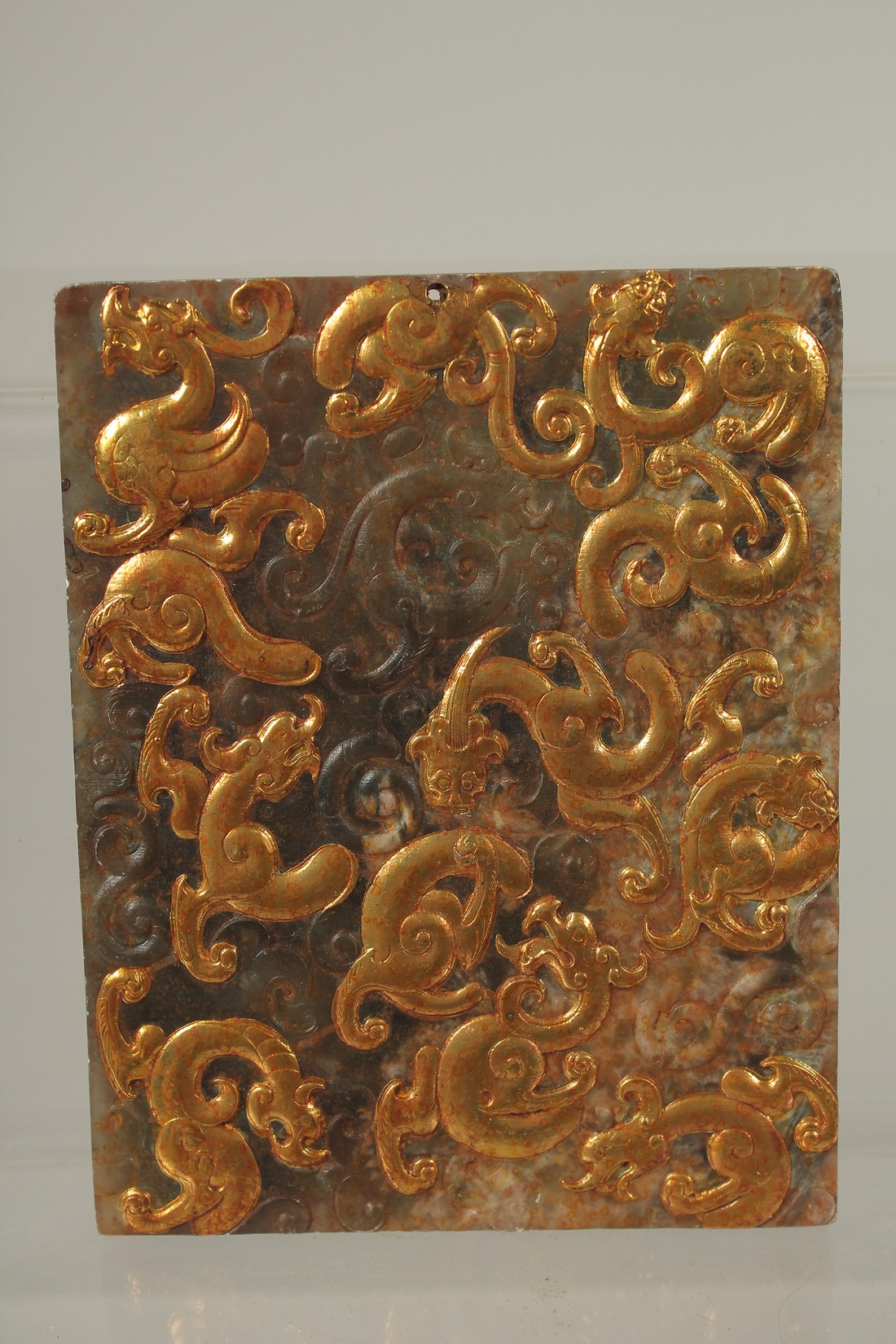 A CHINESE GILDED JADE OR HARDSTONE PLAQUE / PENDANT, 12cm x 9.5cm.