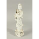 A BLANC-DE-CHINE PORCELAIN FIGURE OF GUANYIN STOOD UPON A LILYPAD, with fine floral details to the