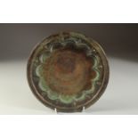 A FINE 13TH CENTURY PERSIAN SELJUK ENGRAVED BRASS DISH, depicting a mythical creature in the