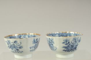 A PAIR OF CHINESE BLUE AND WHITE PORCELAIN TEA BOWLS, with gilded rims and decorated with precious