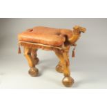 A EARLY-MID 20TH CENTURY EGYPTIAN CARVED WOOD CAMEL STOOL, with original embossed leather cushion,