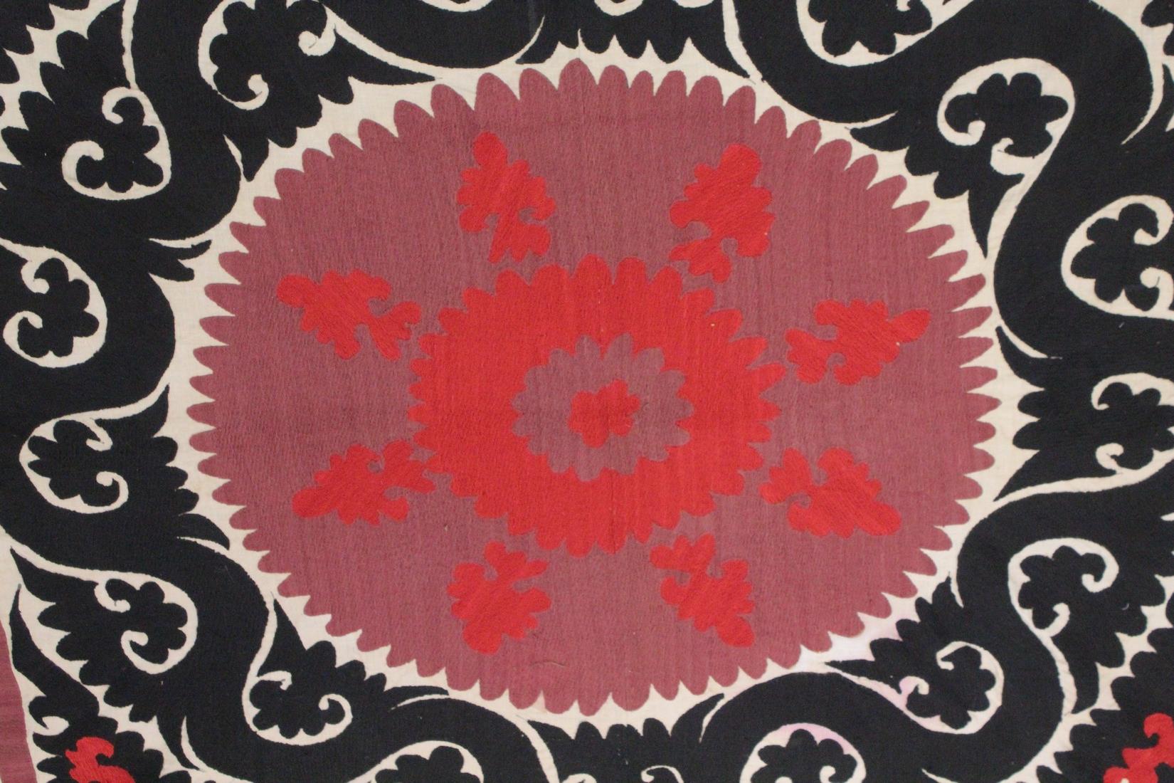 AN UZBEK SUZANI EMBROIDERED TEXTILE, with maroon, red, and black motif on cream ground, 158cm x - Image 2 of 3