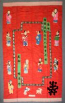 A LARGE EARLY 20TH CENTURY CHINESE RED SILK WALL HANGING with floral embroidered border and