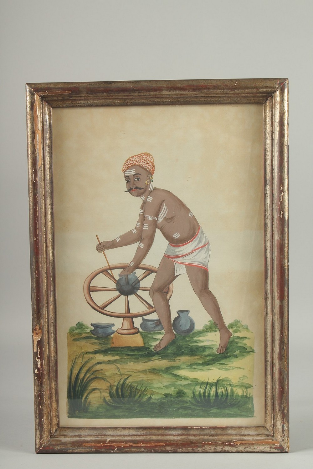 A LARGE EARLY 19TH CENTURY INDIAN WATERCOLOUR PAINTING, depicting a potter, framed and glazed, image