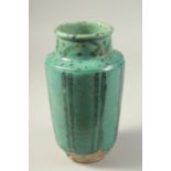 A PERSIAN KASHAN TURQUOISE GLAZED POTTERY VASE, 24cm high.
