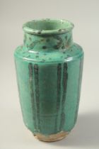 A PERSIAN KASHAN TURQUOISE GLAZED POTTERY VASE, 24cm high.