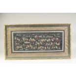 A CHINESE EMBROIDERED SILK 'HUNDRED BOYS' TEXTILE, framed and glazed, textile 31.5cm x 65cm.