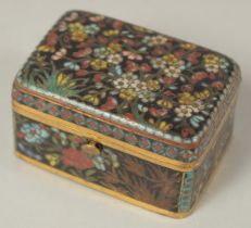 A FINE JAPANESE MEIJI PERIOD BLACK GROUND CLOISONNE BOX, with floral decoration and hinged lid, 5.