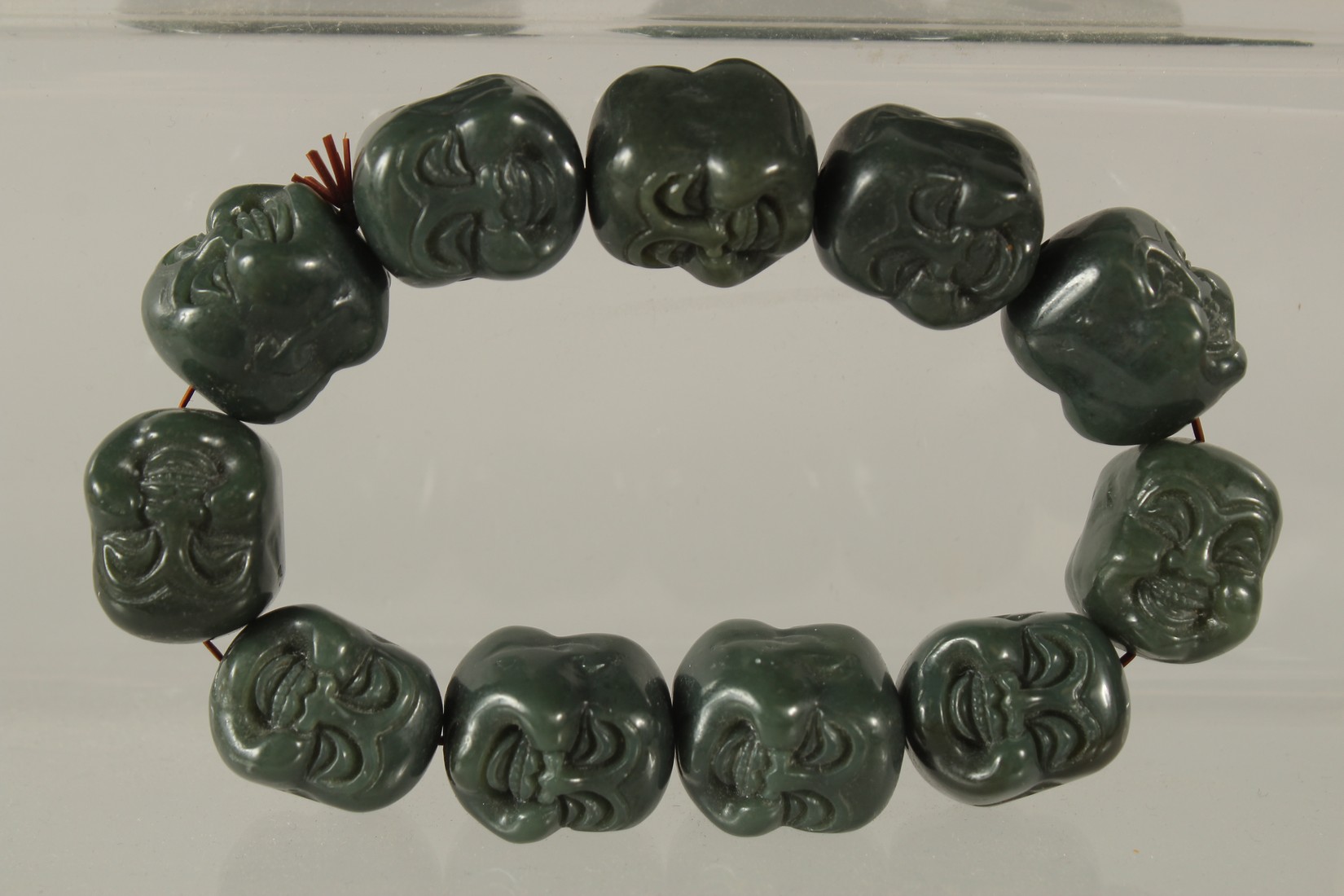 A COLLECTION OF THREE CARVED GREEN HARDSTONE PIECES, (3). - Image 4 of 4