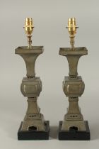 A PAIR OF 19TH CENTURY GU-FORM PEWTER VASES CONVERTED TO LAMPS, 42.5cm high overall.