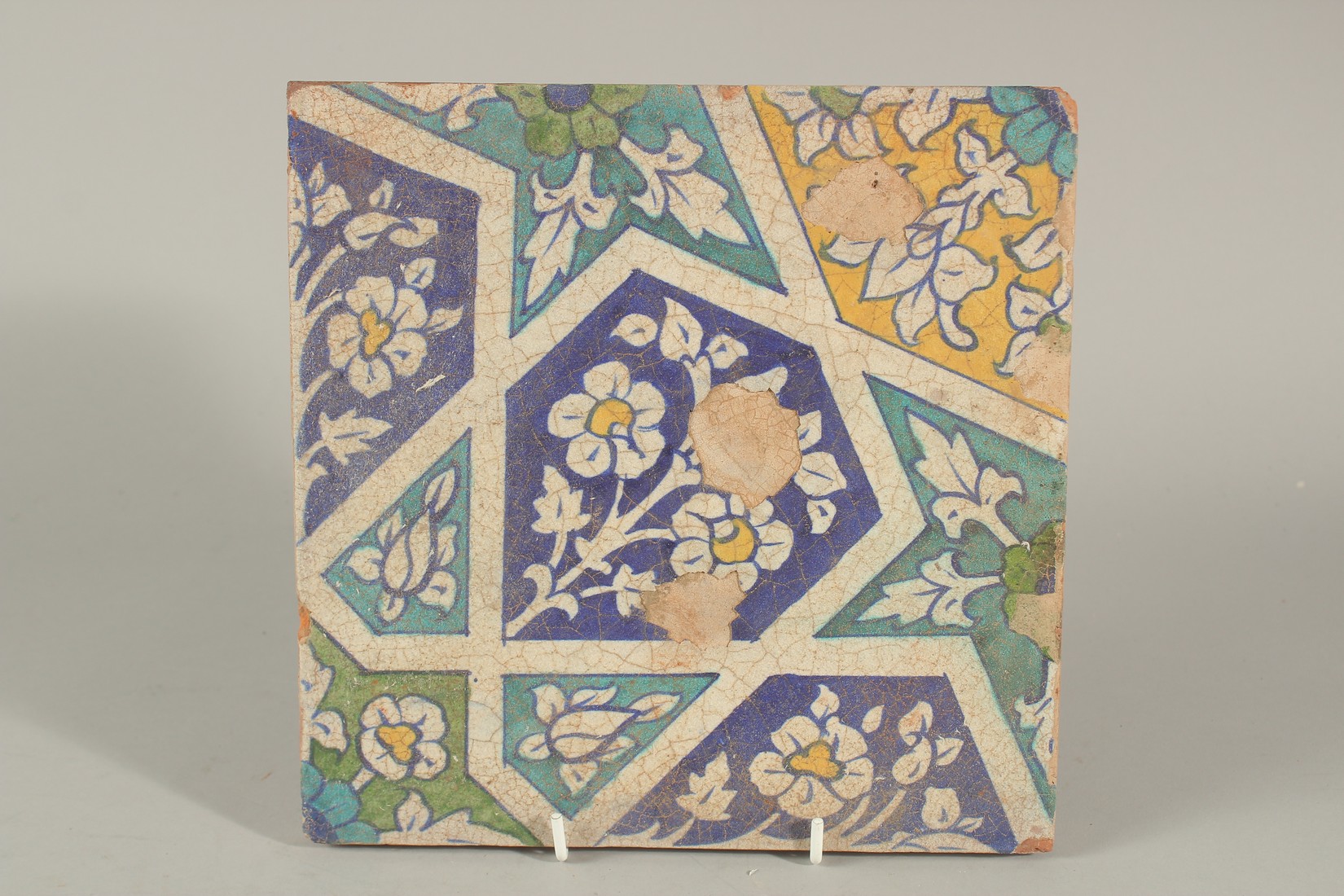 A FINE 18-19TH CENTURY MUGHAL INDIAN MULTAN POTTERY TILE WITH GEOMETRIC DESIGNS, 23cm square.