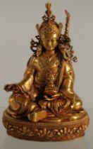 A TIBETAN GILDED BRONZE BUDDHA, 10.5cm high.