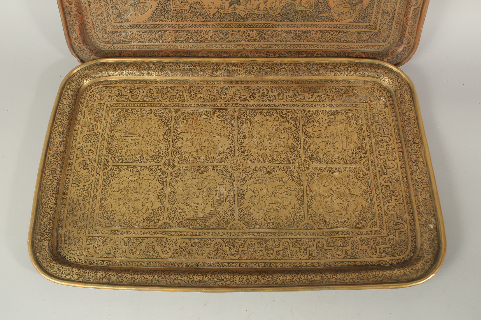 TWO FINE PERSIAN QAJAR BRASS ENGRAVED TRAYS, with pictorial panels, 58cm x 37.5cm and 58.5cm x 38. - Image 3 of 3