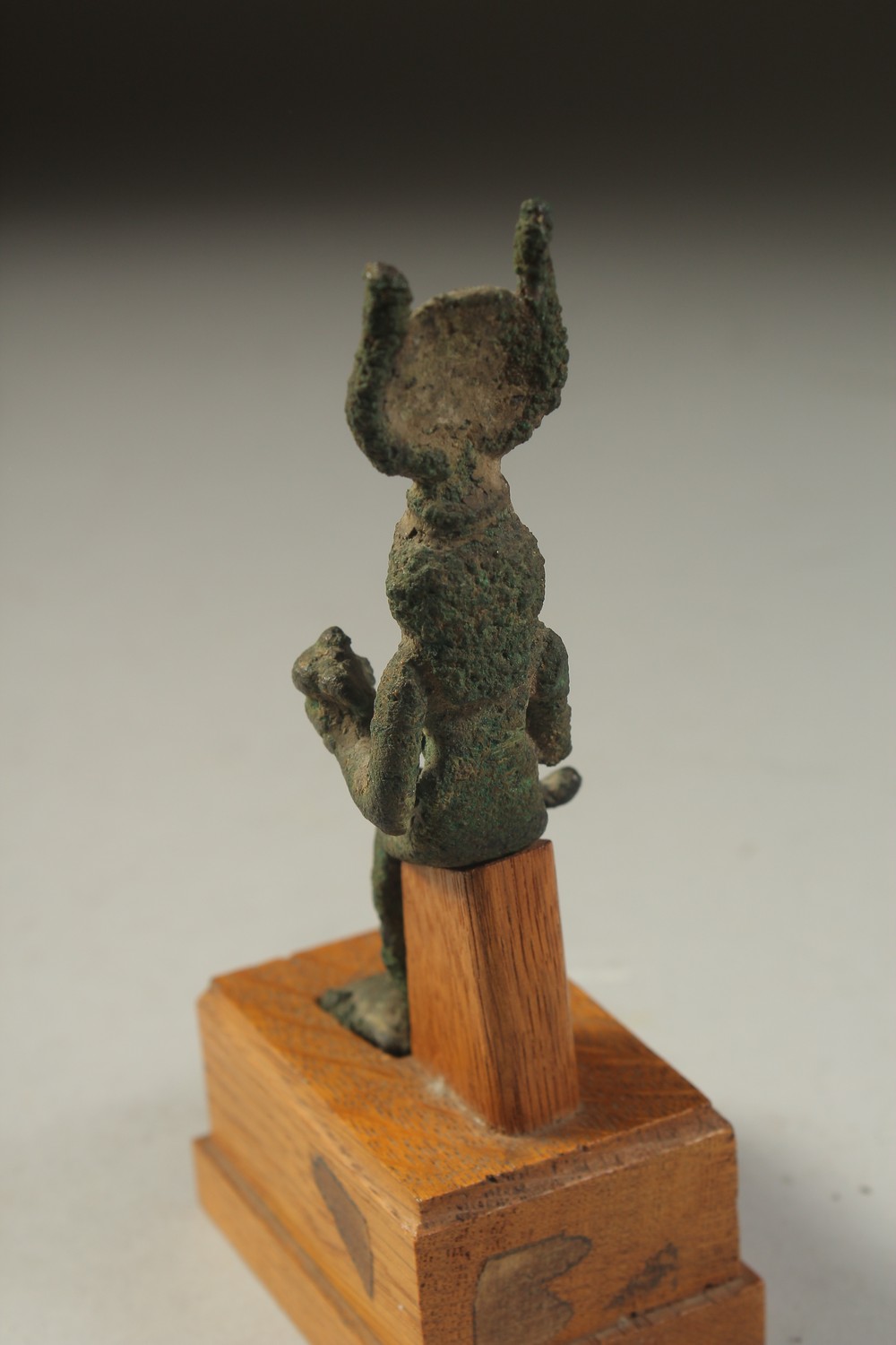 A RARE ANCIENT EYGPTIAN BRONZE FIGURE OF ISIS NURTURING HORUS, on a wooden stand, bronze 12cm high. - Image 4 of 4