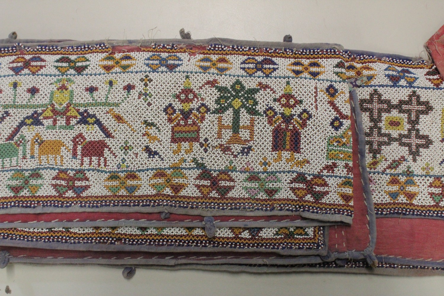 AN EARLY 20TH CENTURY WESTERN INDIAN GUJARAT LONG BEADWORK PANEL, with polychrome stylised geometric - Image 4 of 7