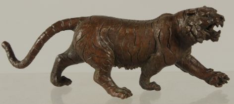 A BRONZE OKIMONO OF A TIGER, 15cm long.