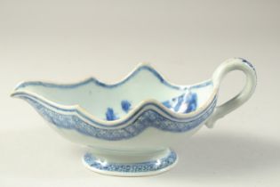 A 19TH CENTURY CHINESE BLUE AND WHITE PORCELAIN SAUCE BOAT, the interior decorated with flora, 23.