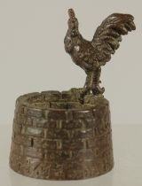 A BRONZE OKIMONO OF A ROOSTER ON A WELL, the interior of the well with a small frog, 5cm high.